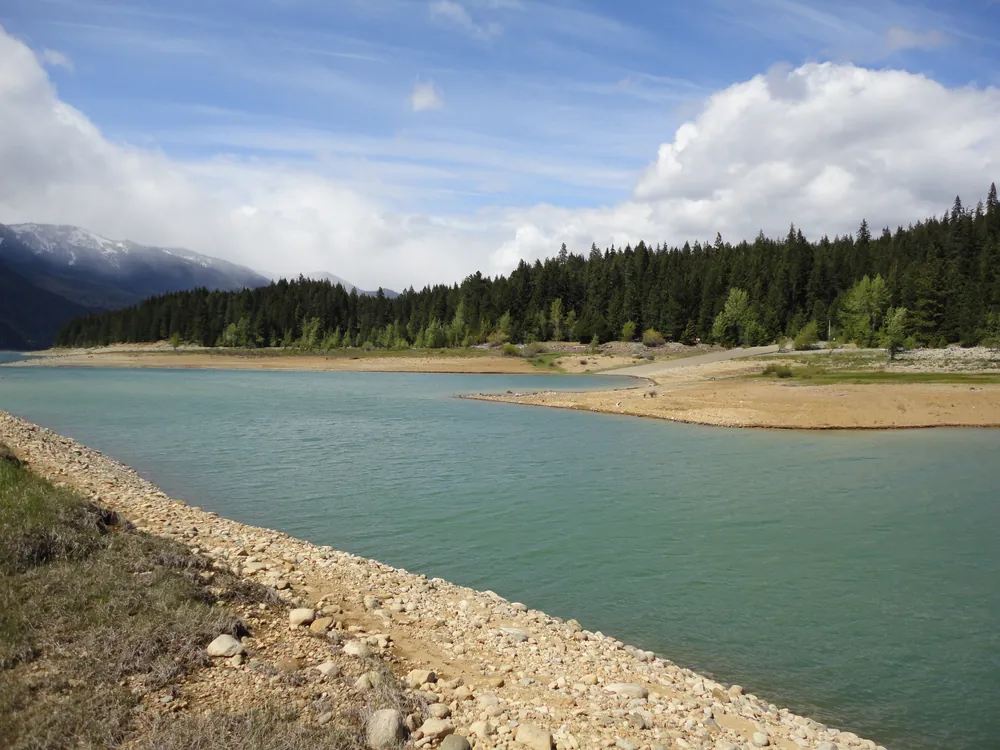 Turquoise mountain lake edged by evergreen forest, from one of the owners' trips