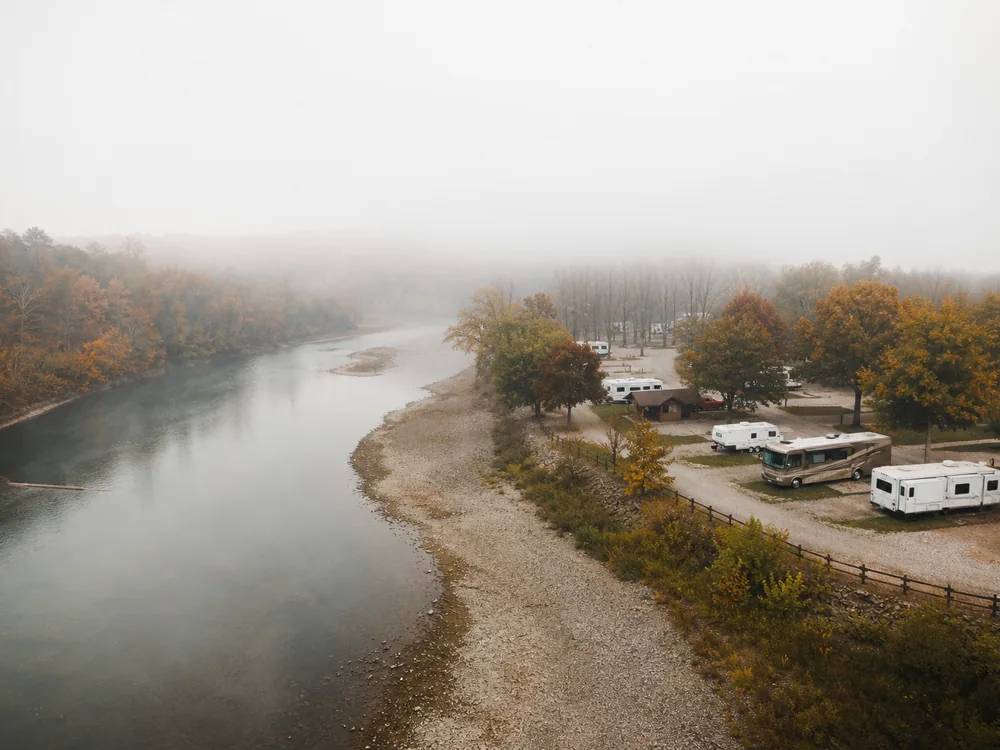 River bend half revealed in fog, an RV park marketing budget before the costs come clear