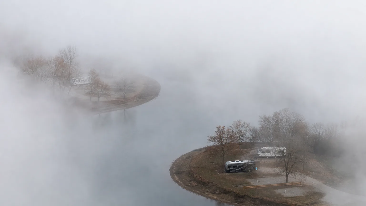 River bend with RV sites on a spit of land, heavy morning fog