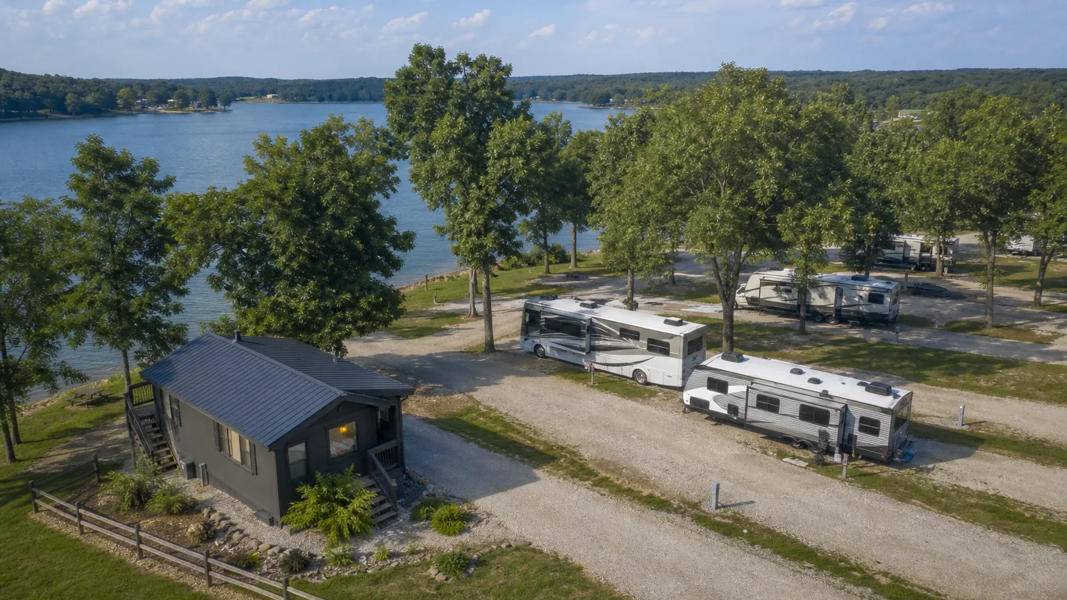 Lakeside or riverside sites at an RV park in bright midday light