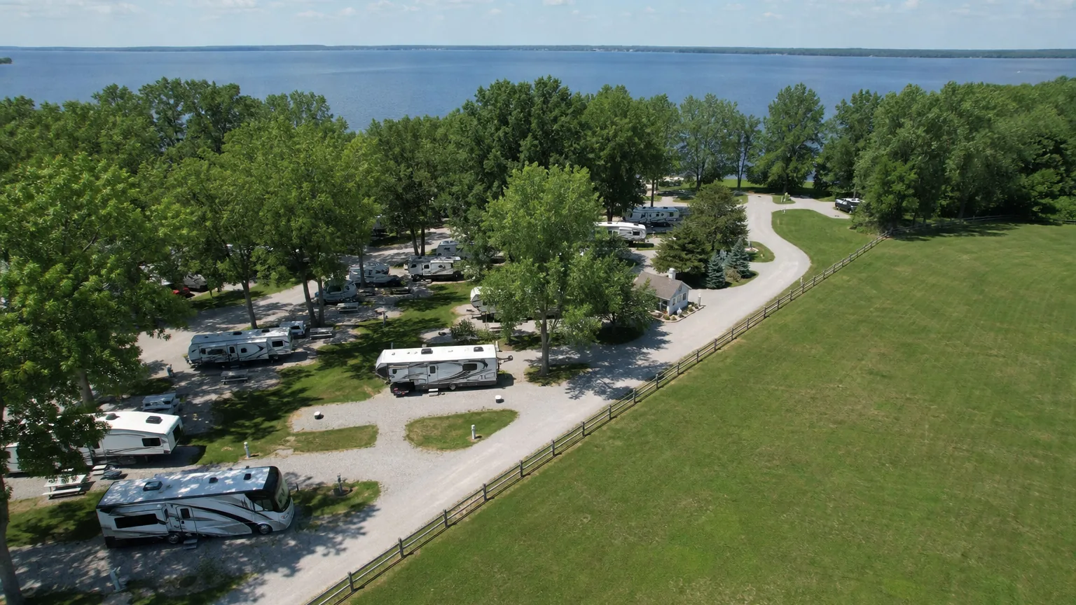 Aerial view of lakeside RV park sites at midday