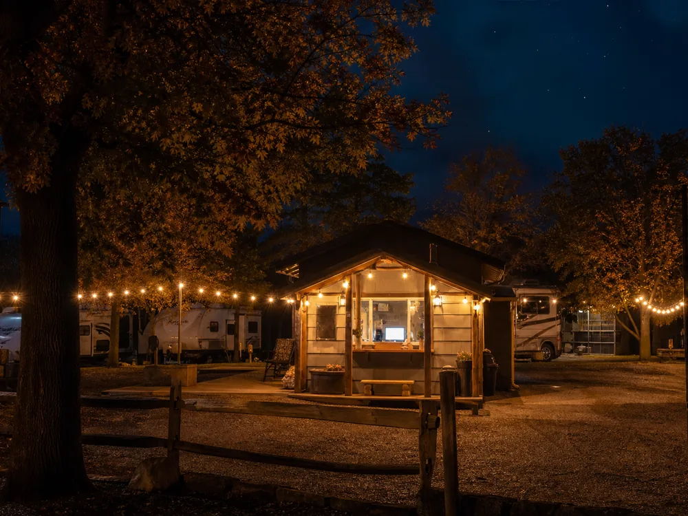 Camp store exterior at an RV park in ambient string lights
